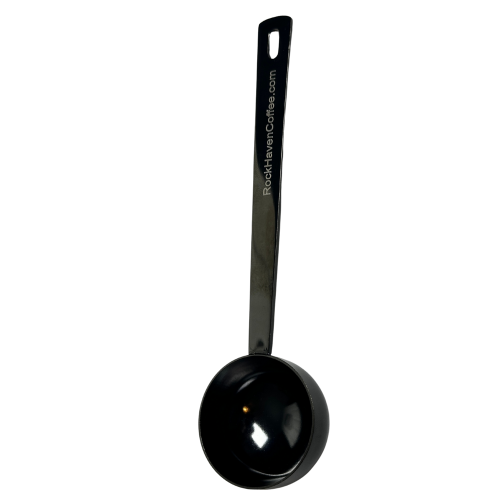 Black measuring spoon on a white background